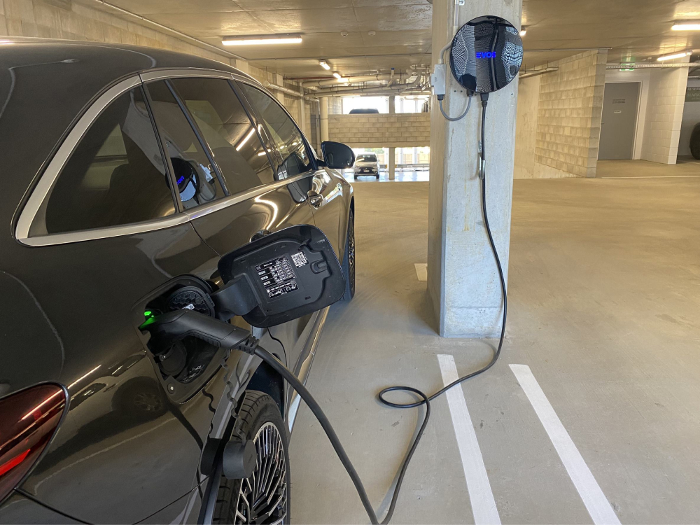 EVOS staff charging an electric vehicle during a road trip in Australia